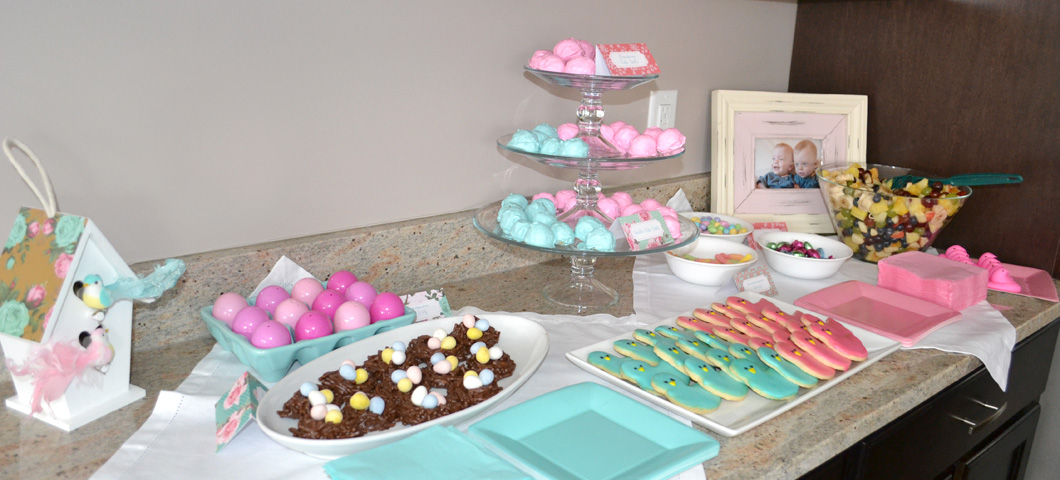 Pink- and aqua-colored goodies dress up a dessert table for a "little birdies" spring birthday party.